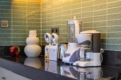 a kitchen counter with a blender on a counter top at Erianthe Peaceful 3 BR Private Pool Villa in Kerobokan