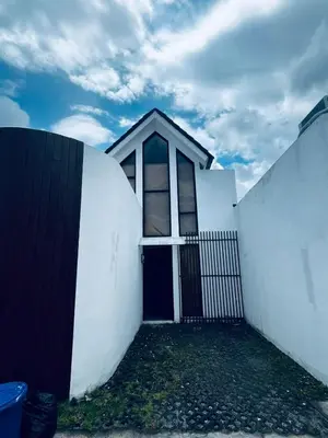 a white house with a black gate and a fence at Della Solea Seminyak in Seminyak