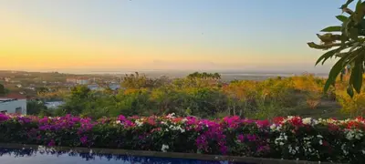 a view of a garden with flowers in the foreground at Mahita Garden Villa 3 Bedroom with Amazing view in Jimbaran