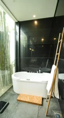 a bathroom with a bath tub and a shower at Mahita Garden Villa 3 Bedroom with Amazing view in Jimbaran