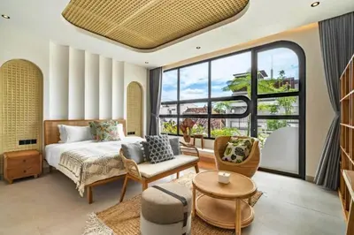 a bedroom with a bed and a large window at Omarosa Stunning 3 BR Private Pool Villa in Kerobokan