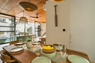 a kitchen and dining room with a table and chairs at Omarosa Stunning 3 BR Private Pool Villa in Kerobokan