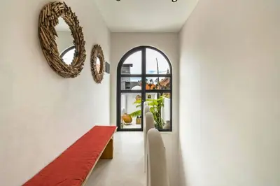 a hallway with a red bench and a mirror at Omarosa Stunning 3 BR Private Pool Villa in Kerobokan