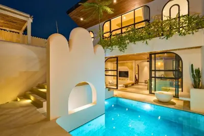 a home with a swimming pool and a house at Omarosa Stunning 3 BR Private Pool Villa in Kerobokan
