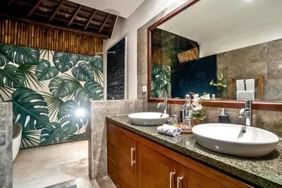 a bathroom with two sinks and a large mirror at Monique 3 BR Private Pool Villa in Seminyak