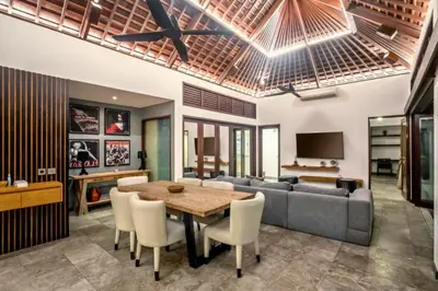 a living room with a table and a couch at Monique 3 BR Private Pool Villa in Seminyak