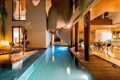 a swimming pool with a slide in a house at Sayara Modern 3 BR Private Pool Villa in Seminyak