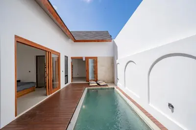 a house with a swimming pool in the middle of a house at Il Petrucino Villa by Damaresa in Nusa Dua