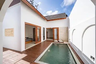 a house with a swimming pool in the middle of a house at Il Petrucino Villa by Damaresa in Nusa Dua