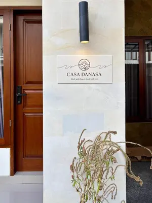 a sign on a wall in front of a door at Casa Danasa, secure and serene Villa at the heart of Seminyak with 24hr One Gate Security in Seminyak