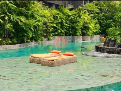 a swimming pool with two beds in the water at Newly Lavaya Resort 1BR with pool in Nusa Dua