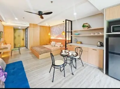 a living room with a bed and a table and chairs at Newly Lavaya Resort 1BR with pool in Nusa Dua