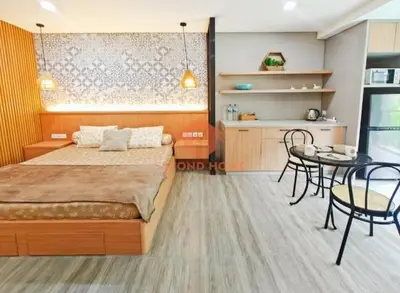a bedroom with a bed and a table and chairs at Newly Lavaya Resort 1BR with pool in Nusa Dua