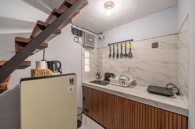a kitchen with a refrigerator and a sink at Cozy Mezzanine Near Airport & Jimbaran Beach in Ngurah Rai International Airport