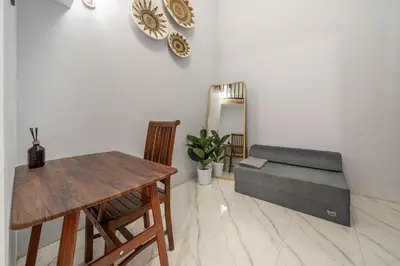 a living room with a couch and a table at Cozy Mezzanine Near Airport & Jimbaran Beach in Ngurah Rai International Airport