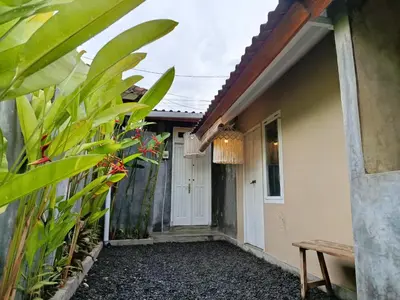 a walkway to the front door of a house at Gusti Ayu Private Bali House - 2 Bedrooms near Canggu & Seminyak in Kerobokan
