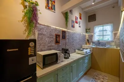 a kitchen with a counter top with a microwave at Palm Villa 4 , Seminyak Center in Seminyak
