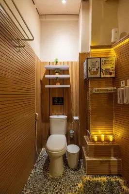 a bathroom with a toilet and a bath tub at Palm Villa 4 , Seminyak Center in Seminyak