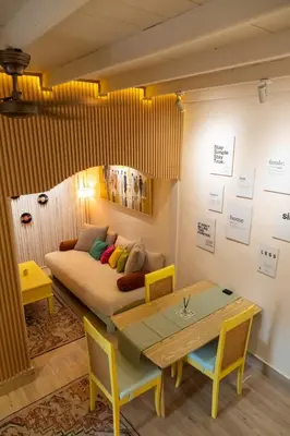 a living room with a couch and a table at Palm Villa 4 , Seminyak Center in Seminyak