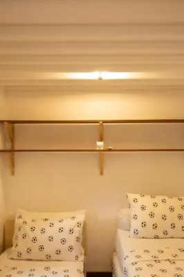 two beds in a room with a cross on the wall at Charming Two Bedroom Villa Near Seminyak Beach in Seminyak