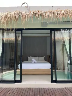 a bedroom with a bed and a glass window at Ametys 1 Villa - Cozy 2BR Villa with Private Pool & Prime Seminyak in Seminyak