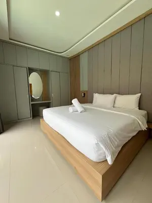 a bedroom with a large white bed in it at Ametys 1 Villa - Cozy 2BR Villa with Private Pool & Prime Seminyak in Seminyak