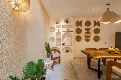 a dining room with a wooden table and a dining room at The Shalak Villa Bali in Denpasar