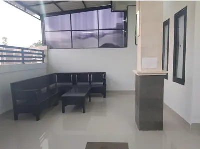 a room with two black benches and a window at Chandra's house in Pesanggaran