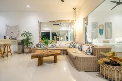 a living room with a couch and a table at Villa GR888 - 3BR Tropical Comfort Seminyak in Seminyak