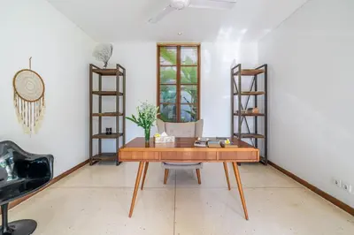 a room with a wooden desk and a chair at Lux Ayuni Big Modern 2BR Designer Villa Berawa in Canggu