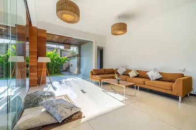 a living room with two couches and a table at Lux Ayuni Big Modern 2BR Designer Villa Berawa in Canggu