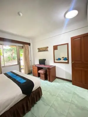 a bedroom with a bed and a desk in it at The Beach Residence at Jayakarta Resort Bali in Seminyak