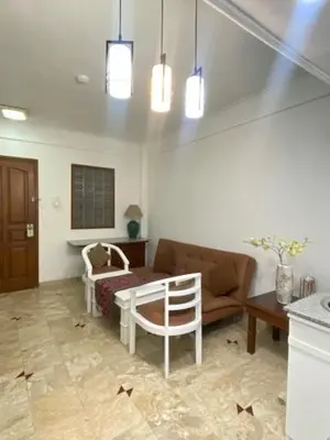 a living room with a couch and a chair at The Beach Residence at Jayakarta Resort Bali in Seminyak