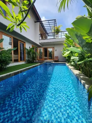 a swimming pool in front of a villa at Best Villa in Jimbaran