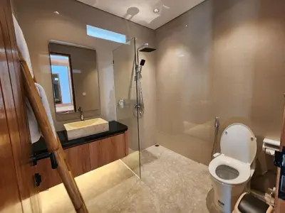 a bathroom with a toilet and a sink and a shower at Best Villa in Jimbaran