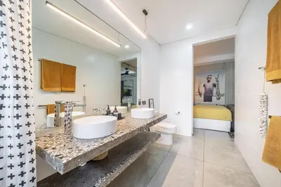 a bathroom with two sinks and a toilet at Villa 111 - Romantic 1BR Villa in Batu Belig in Seminyak
