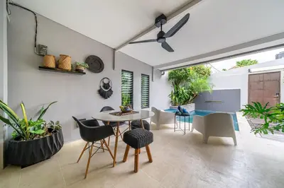 a dining room with a table and chairs at Villa 111 - Romantic 1BR Villa in Batu Belig in Seminyak