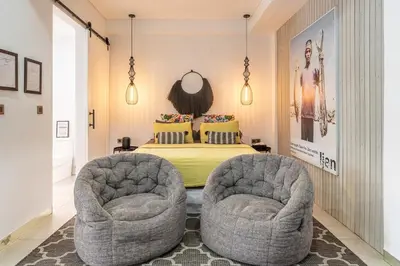two chairs in a bedroom with a bed at Villa 111 - Romantic 1BR Villa in Batu Belig in Seminyak