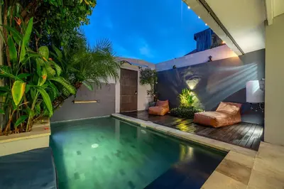 a swimming pool in the middle of a house at Villa 111 - Romantic 1BR Villa in Batu Belig in Seminyak