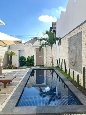a swimming pool in the backyard of a house at Mediterranean Villa Sanur Beach in Sanur