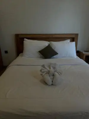 a stuffed animal is sitting on a bed at Mediterranean Villa Sanur Beach in Sanur