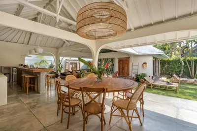 an open kitchen and dining room with a table and chairs at Villa Anicca - Family-Friendly 4BR Villa Umalas With Private Pool And Rooftop Lounge in Canggu
