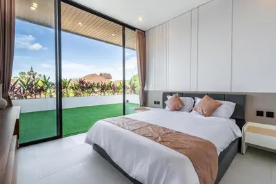 a bedroom with a large bed and a large window at New Villa 3BR Umalas Pool Near Seminyak and Canggu in Canggu