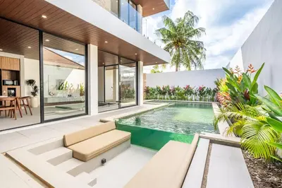 an open living room with a swimming pool and a house at New Villa 3BR Umalas Pool Near Seminyak and Canggu in Canggu