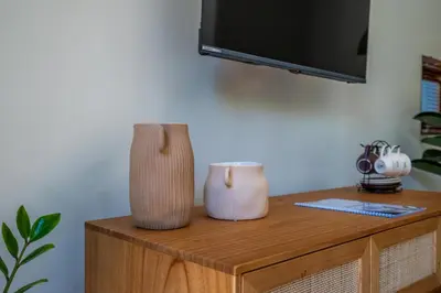two vases sitting on top of a wooden cabinet at Semar Villa, a cozy studio Villa with a Private Pool, Bali in Legian