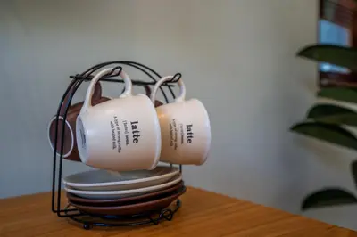a pair of tea cups sitting on top of a stack of plates at Semar Villa, a cozy studio Villa with a Private Pool, Bali in Legian