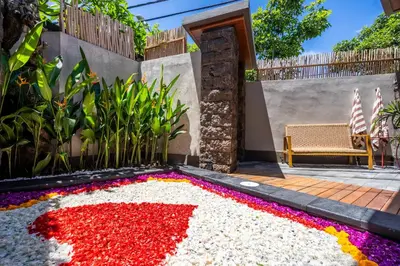 a garden with a bunch of flowers on the ground at Semar Villa, a cozy studio Villa with a Private Pool, Bali in Legian