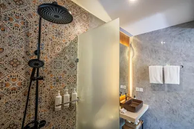 a bathroom with a shower and a sink at Semar Villa, a cozy studio Villa with a Private Pool, Bali in Legian