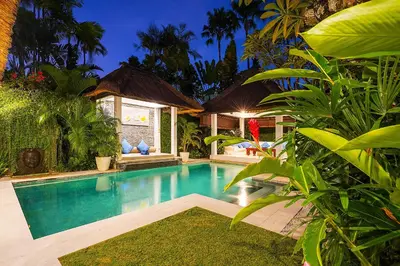 a swimming pool in front of a house at Superb and Elegant 3-Bedroom Villa Close to the Beach in Seminyak
