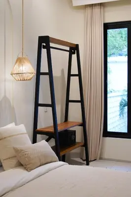 a room with a book shelf and a bed at Private 3BR Villa Sweetie with Pool Seminyak in Seminyak